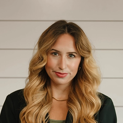 Financial Coordinator Isabella Lehtonen In Front Of Wall