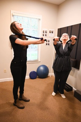 Patient Doing Rehab Exercises With Staff Member At Combs Chiropractic & Wellness