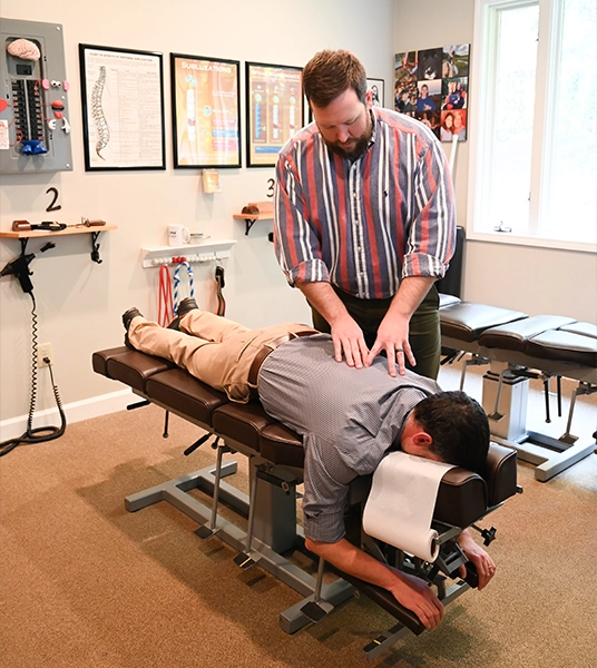 Chiropractor Alex Combs Adjusting Patient