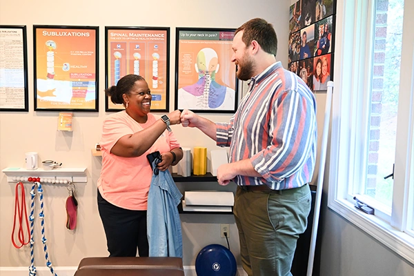 Chiropractor Alex Combs Fist Bumping Patient